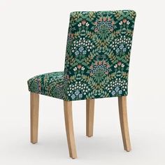 a green floral patterned chair with wooden legs and back rest, viewed from the front