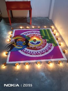 a decorated floor with candles and lights around it