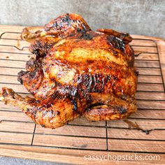 a whole chicken is sitting on a cooling rack