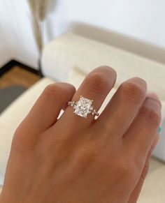 a woman's hand with a diamond ring on it