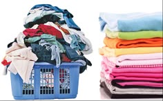 a blue basket filled with clothes next to a pile of folded shirts on top of each other