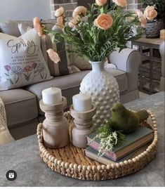 a coffee table with flowers and candles on it