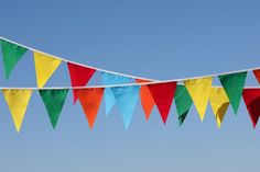 multicolored bunting flags are hanging in the air