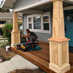 a man is working on the front porch