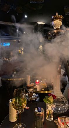 steam rising from the top of a table with wine glasses and other items on it