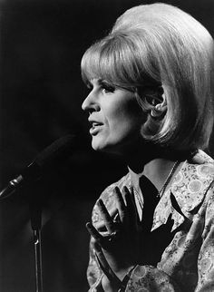 an old photo of a woman singing into a microphone