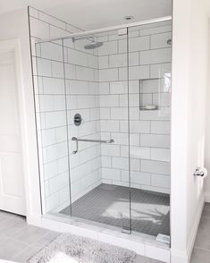 a walk in shower sitting inside of a bathroom