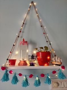 a shelf with potted plants and lights on it