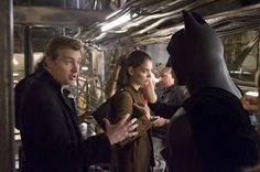 a man in a batman costume talking to a woman