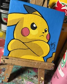 a painting of a pikachu sitting on an easel