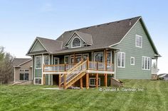 a large house sitting on top of a lush green field