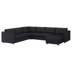 a black sectional couch sitting on top of a white floor