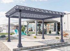 a pergolated area with chairs and tables in the background at an rv park