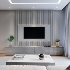 a modern living room with a flat screen tv on the wall