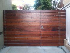 a wooden gate in front of a house