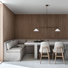 a living room and dining area are shown in this modern style house with wood paneling on the walls