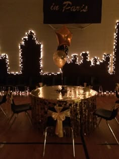 the table is decorated with balloons and streamers for an elegant celebration in paris, france