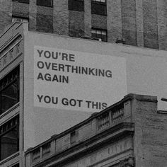 a sign on the side of a building that says, you're overthinking again you got this