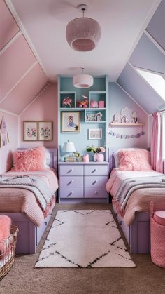 two beds in a room with pink and blue walls, rugs on the floor