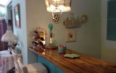 a room with a wooden counter and blue shutters