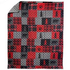 a red and black quilted blanket with trees on it's side, in the middle