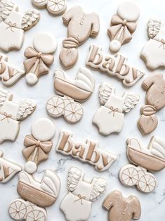 baby shower cookies are arranged on a marble surface