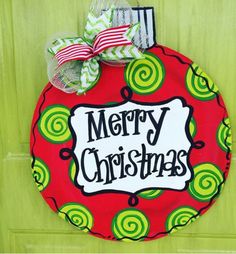 a christmas door hanger on a green door