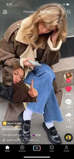 a woman sitting on top of a bench next to a man holding a cell phone