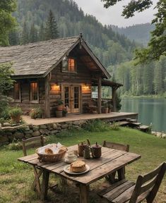 a picnic table with food on it in front of a cabin