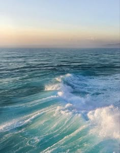 the ocean is blue and green with waves