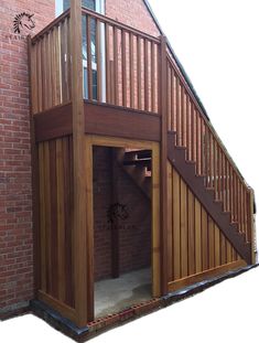 an open door to a brick building with stairs leading up to the upper floor and second story