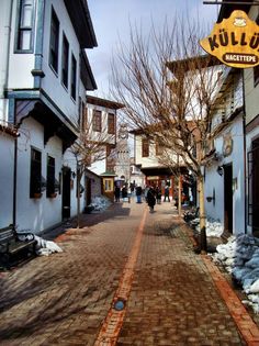 people walking down the street in an old town