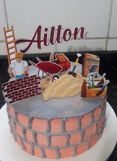 there is a cake that has been made to look like a brick wall and construction site