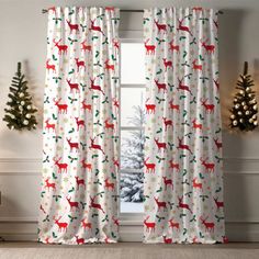 the curtains are decorated with deers and christmas trees in red, white and green