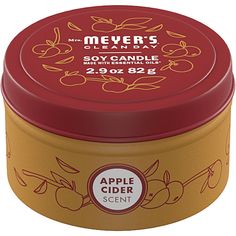 an apple cider scented candle in a tin