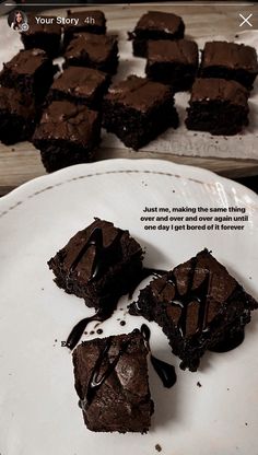 some brownies are on a white plate with chocolate drizzled on them