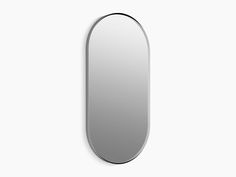 an oval mirror on the wall with a black frame and silver trim around it's edge