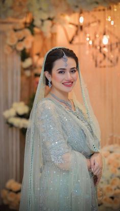 a woman in a wedding dress posing for the camera