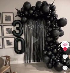 the balloon arch is decorated with black balloons