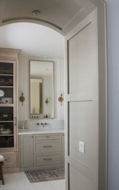 an open door leading to a white bathroom