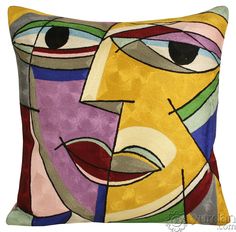 a decorative pillow with an abstract painting on the front and side of it's face