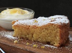 a piece of cake sitting on top of a wooden cutting board