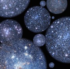 several blue and white bubbles floating in the air with stars around them on a black background