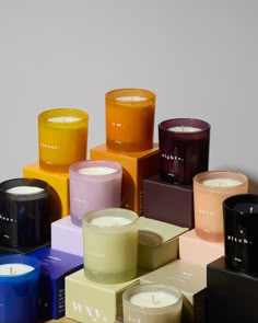 many different colored candles sitting next to each other