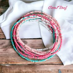 Dive into the enchanting depths of the ocean with our "Coral Reef" seed bead bracelet. inspired by the vibrant hues of a tropical reef, this stunning accessory features a mesmerizing combination of coral, white and teal seas beads woven together to evoke the beauty and diversity of underwater life. This extra-long design allows you to wrap it around your wrist 12 times (on an average 7 inch wrist) for a layered look or even wear it as a necklace or anklet for added flair! 🪸🐠 Dive in and make a Beach Bracelets With Spacer And Round Beads, Adjustable Polished Bead Bracelets For Beach, Colorful Heishi Beads Strand Bracelet, Adjustable Polished Beads Bracelet For Beach, Adjustable Polished Beads Bracelets For Beach, Beach Bangle Beaded Bracelets With Spacer Beads, Pink Bohemian Strand Beaded Bracelets, Summer Beach Bracelets With Faceted Beads, Beach Jewelry Faceted Bead Bracelets