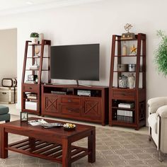 a living room filled with furniture and a flat screen tv on top of a wooden stand