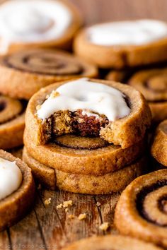 cinnamon roll cookies with icing on a wooden table