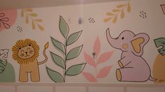 an elephant, lion and giraffe mural on the wall in a children's room