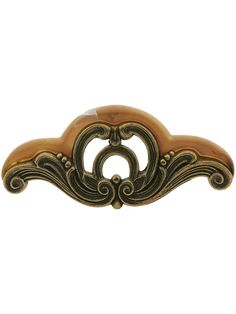 an antique brass finish door handle with scroll design on the front and back side,