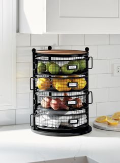 a stack of fruit and vegetables sitting on top of a counter